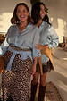 Two models wear the Ice Blue Miley Shirt with blouson sleeves and tortoise buttons, highlighting inclusive sizing.