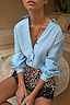 Ice Blue Miley Shirt with blouson sleeves and tortoise buttons, styled with leopard print lace shorts.