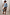 Thumbnail for Ice Blue Miley Shirt with blouson sleeves and embroidered back neck logo, styled with a leopard print skirt.