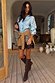 Ice Blue Miley Shirt with blouson sleeves and tortoise buttons, styled with a leopard skirt and brown boots.