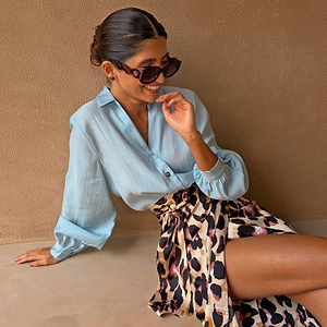 Ice Blue Miley Shirt with blouson sleeves paired with a leopard print Jaspre wrap skirt.