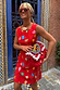 Thumbnail for Red Shell Ioana Mini Dress in cotton-linen with a multicoloured shell print, red sunglasses and a crochet bag.