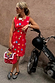 Red Shell Ioana Mini Dress featuring a multicoloured shell print, styled on a model leaning against a moped.