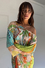 Isla Jem Dress in multi-colour plisse featuring hand-painted island motifs and an off-the-shoulder neckline.