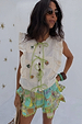 Cream cotton-linen Isla Tia Top with green tie-front fastenings, ruffle lace trim and iconic NFD motifs.