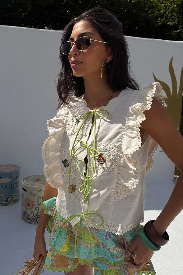 Cream Isla Tia Top featuring ruffled lace sleeves, lime green tie-fronts and embroidered motifs in a cotton-linen blend.