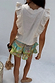 Cream Isla Tia Top in a cotton-linen blend with ruffle details and lace trim, shown from the back.