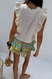 Cream Isla Tia Top in a cotton-linen blend with ruffle details and lace trim, shown from the back.