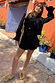 Thumbnail for Black Isla top and ruffle shorts co-ord with lace trim and sun embroidery in a sunny outdoor setting.