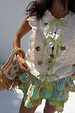 Cream Isla Tia Top with lime green tie-front, embroidered motifs and delicate lace trim on a cotton-linen base.