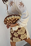 Jaden Beaded Clutch Bag with brown and cream beadwork and large baubles, styled with a white palm-cutout shirt.