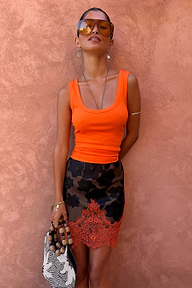 Maeva mini skirt in tan Jaden floral print with a burnt orange lace hem and ribbed orange vest.