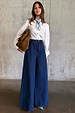 Blue Denim Pallazzo Jan Jean with a wide-leg style and high-waisted fit, paired with a white shirt.