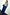 Thumbnail for Blue Denim Pallazzo Jan Jean with a wide-leg fit, styled with a grey knit and leopard print belt on a size 18 model.