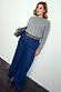 Blue Denim Pallazzo Jan Jean with a wide-leg fit, styled with a grey knit and leopard print belt on a size 18 model.
