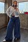 Blue Denim Pallazzo Jan Jean with a voluminous wide-leg fit, styled with a silver cardigan for an effortless London look.