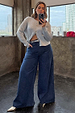 Blue Denim Pallazzo Jan Jean with a voluminous wide-leg fit, styled with a silver cardigan for an effortless London look.