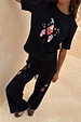 Black Night Garden Knit Joggers with colourful embroidered motifs and pink blanket-stitch side trim.