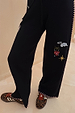 Night Garden Knit Joggers in black with colourful embroidery and pink whipstitch detailing on the side and hem.