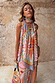 Dolce Vita Josie Mini Dress featuring an iconic eye motif, scarf halterneck and sunset tones.
