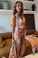 Dolce Vita Josie Mini Dress featuring an iconic eye motif and scarf halterneck in warm sunset tones.