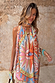 Dolce Vita Josie Mini Dress featuring the iconic eye motif and halterneck scarf tie in sunset tones.