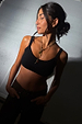 Deloris Thin Chain Key Necklace featuring a gold key charm and red gem, worn with a black crop top.