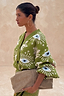 Thumbnail for Khaki Eye Cardigan in a soft green knit with iconic eye and heart motifs, shown from a side profile.