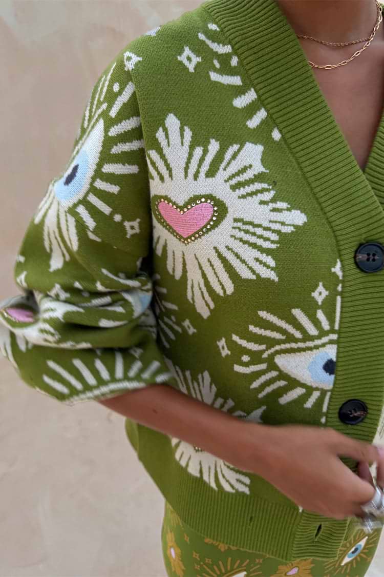 Khaki Eye Cardigan featuring iconic NFD eye and heart motifs on green knitwear with button-up detail.