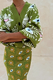 Khaki knit cardigan featuring iconic eye and heart motifs, paired with a matching printed Dorris skirt.