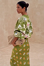 Khaki Eye Cardigan featuring embroidered eye and heart motifs, styled with a matching knitted skirt.