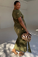 Khaki Shell Midi Dress with a gold seashell print and tie waist, shown on a model wearing size L.