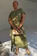Khaki Shell Midi Dress with gold seashell print, short sleeves and multi-wear tie-waist, styled with a beaded clutch.
