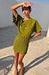 Khaki Mini Plisse Tilly Dress featuring a gold fleck print and wide sleeves on a model in a sunny outdoor setting.
