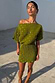 Khaki Tilly mini dress in plisse fabric with a gold fleck print and off-the-shoulder neckline, shown in the sun.