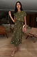 Khaki Shell Midi Dress with gold seashell prints and a side-tie waist detail, worn by a model indoors.