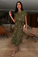Khaki Shell Midi Dress with gold seashell prints and a side-tie waist detail, worn by a model indoors.