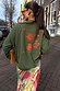 Khaki sweatshirt with orange sun and snake embroidery on the back, styled for a casual London look.