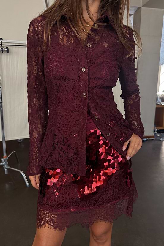 Burgundy Lace Shirt in a delicate lace fabric with flared cuffs, paired with a red sequin mini skirt.