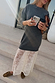 Grey Knit Jumper Dress with a sheer white lace skirt, styled with brown loafers and a coffee on stone steps.