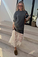 Grey Knit Jumper Dress with a sheer white lace skirt, styled with sunglasses and loafers on stone steps.