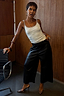 Black Vegan Leather Culottes with a wide leg and front crease, styled with leopard print heels.