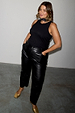 Black vegan leather trousers with a straight leg, styled with a black tank top and gold heels.