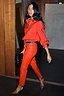 Deep Red Vegan Leather Trousers styled with a matching red shirt, studded belt and leopard heels.