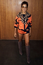 Thumbnail for Iconic Leopard Knit Bandana in a soft-touch print, tied over an orange cardigan set for a multi-wear London look.
