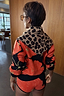 Thumbnail for Iconic Leopard Knit Bandana in a soft-touch animal print, draped over the shoulders as a versatile layering piece.