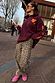 Leopard Barrel Jeans with an iconic print and relaxed barrel leg, styled with a burgundy hoodie for a street style look.
