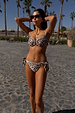 Leopard Whipstitch Bikini Top with blue trim and underwire, paired with matching tie-waist bottoms in a vacation setting.
