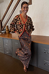 Iconic leopard print cardigan featuring cherry details and red contrast trims, styled with a matching maxi skirt.