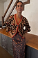 Thumbnail for Knit cardigan in iconic leopard print with red trims and cherry motifs, paired with a matching skirt on a model in size M.